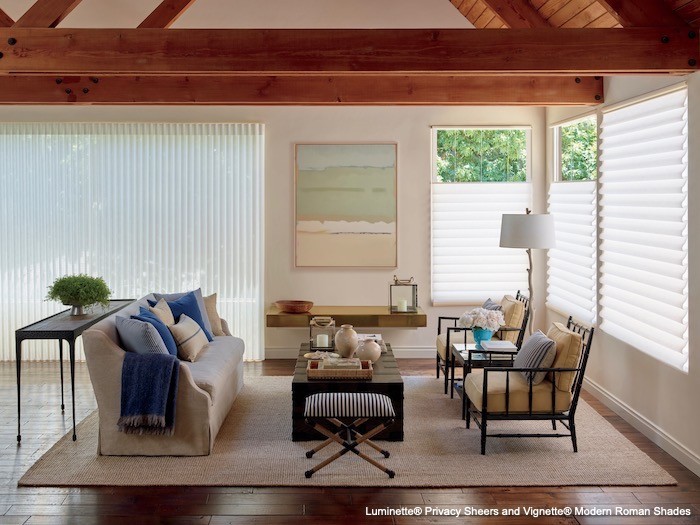 A living room with black wood accents and cream-colored furnishings.