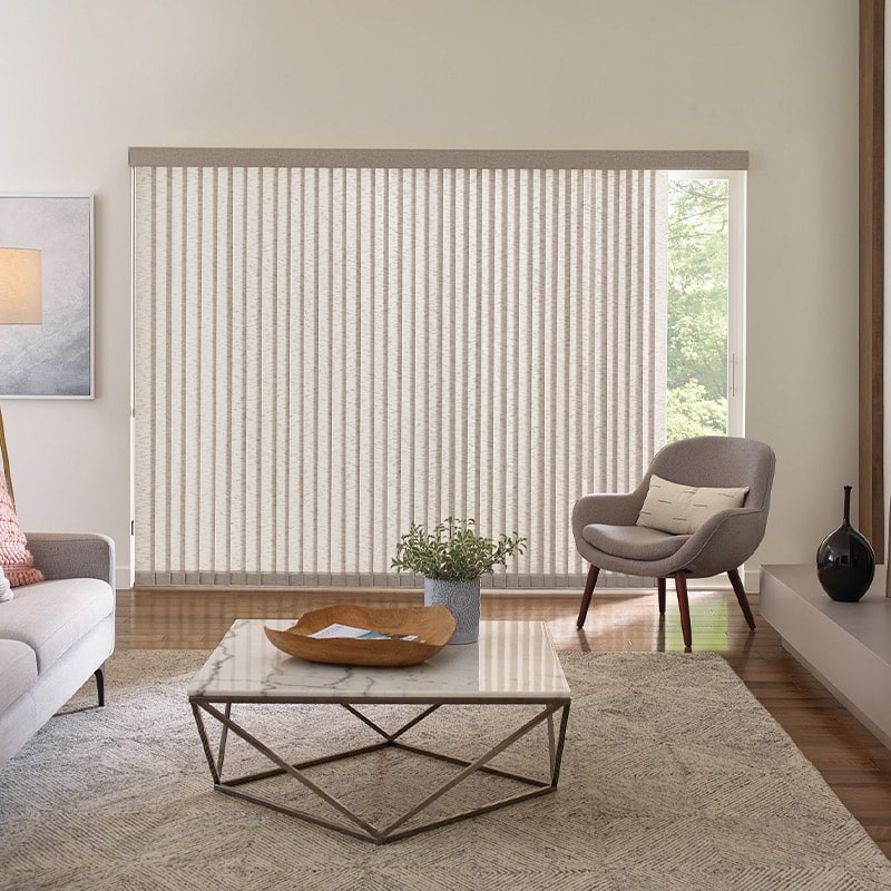 Bright and airy living room with vertical blinds, contemporary furniture, and neutral decor, creating a stylish and functional space for relaxation and natural light.