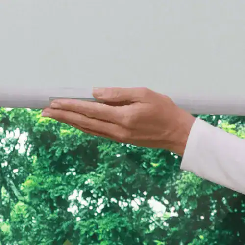 Hand using touchless cleaning technology to wipe windows efficiently and hygienically.
