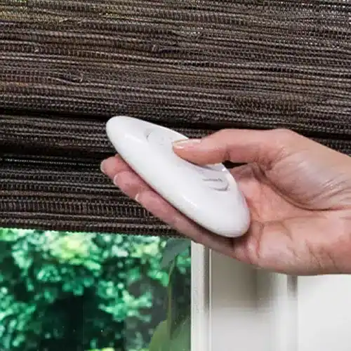 Hand holding a window cleaning device for glass cleaning.