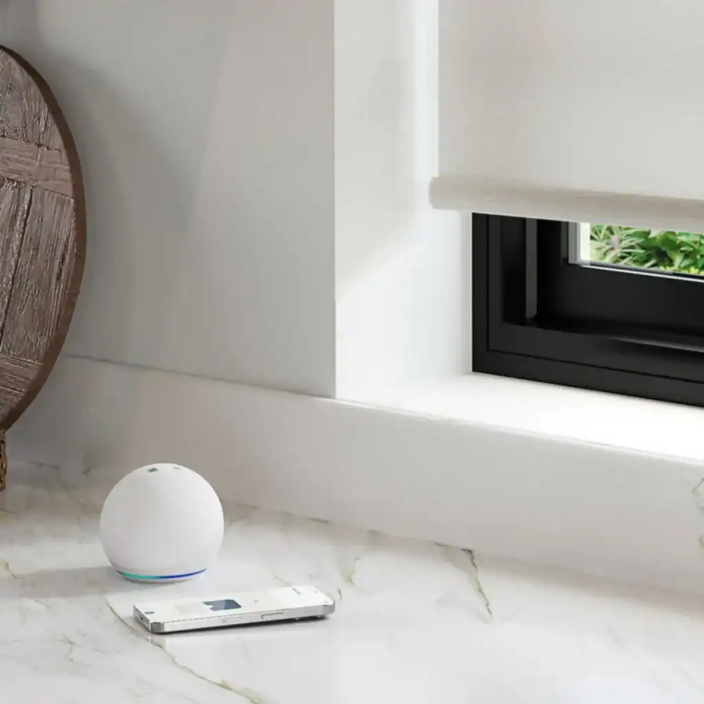 Smart home device with voice assistant on a marble windowsill.